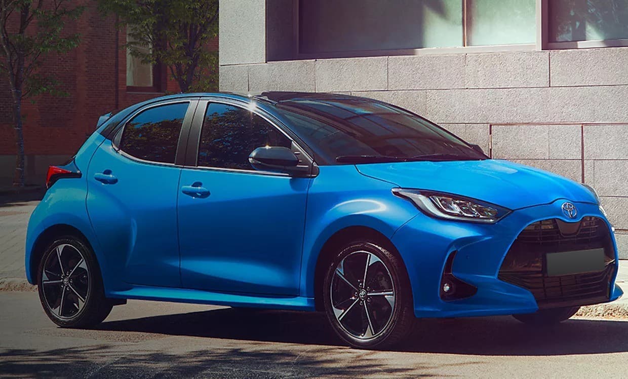 Blue Toyota Yaris Hybrid parked on a city street, front three-quarter view